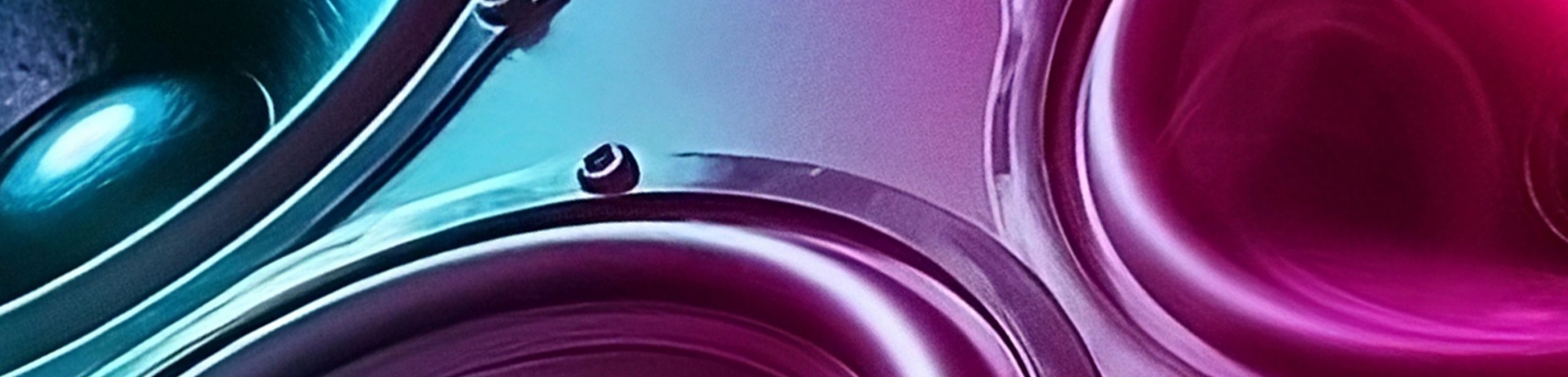 Close-up speaker woofers bathed in blue and purple lighting